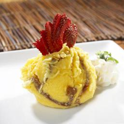 Tempura ice cream with sliced strawberries arranged on top.