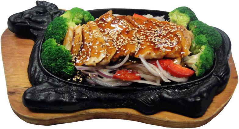 Sliced chicken topped with teriyaki sauce on top of onions, peppers and broccoli served in a plate surrounded with a cow shape.